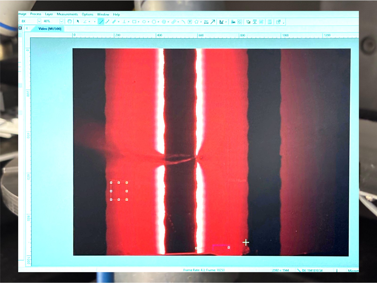 Microscope image of bright red emission along the laser's contact stripe